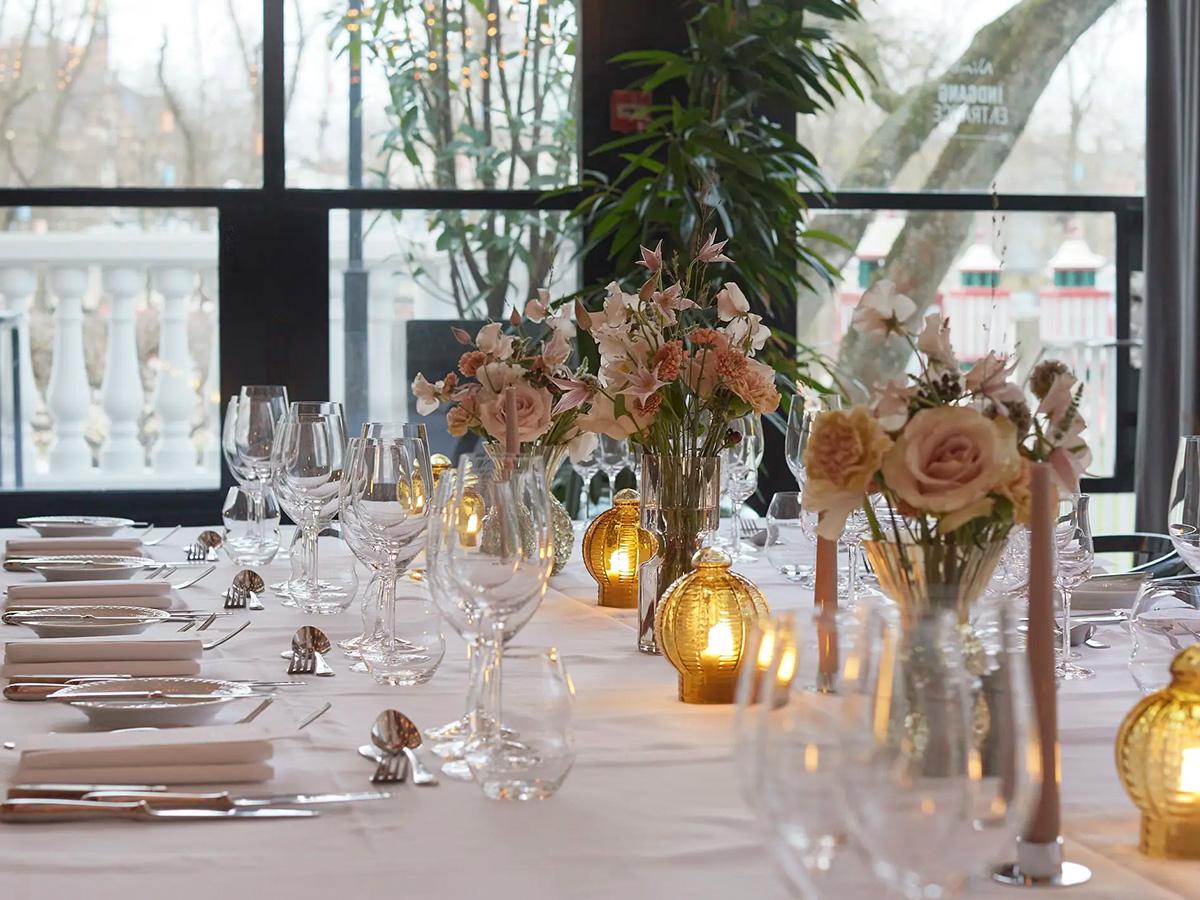 A table set for dinner in Spejlstuen at Nimb Hotel, with windows onto Tivoli Gardens
